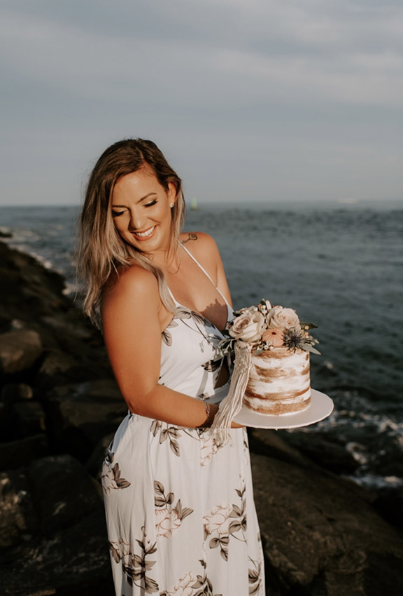 photo of Ashley holding a cake